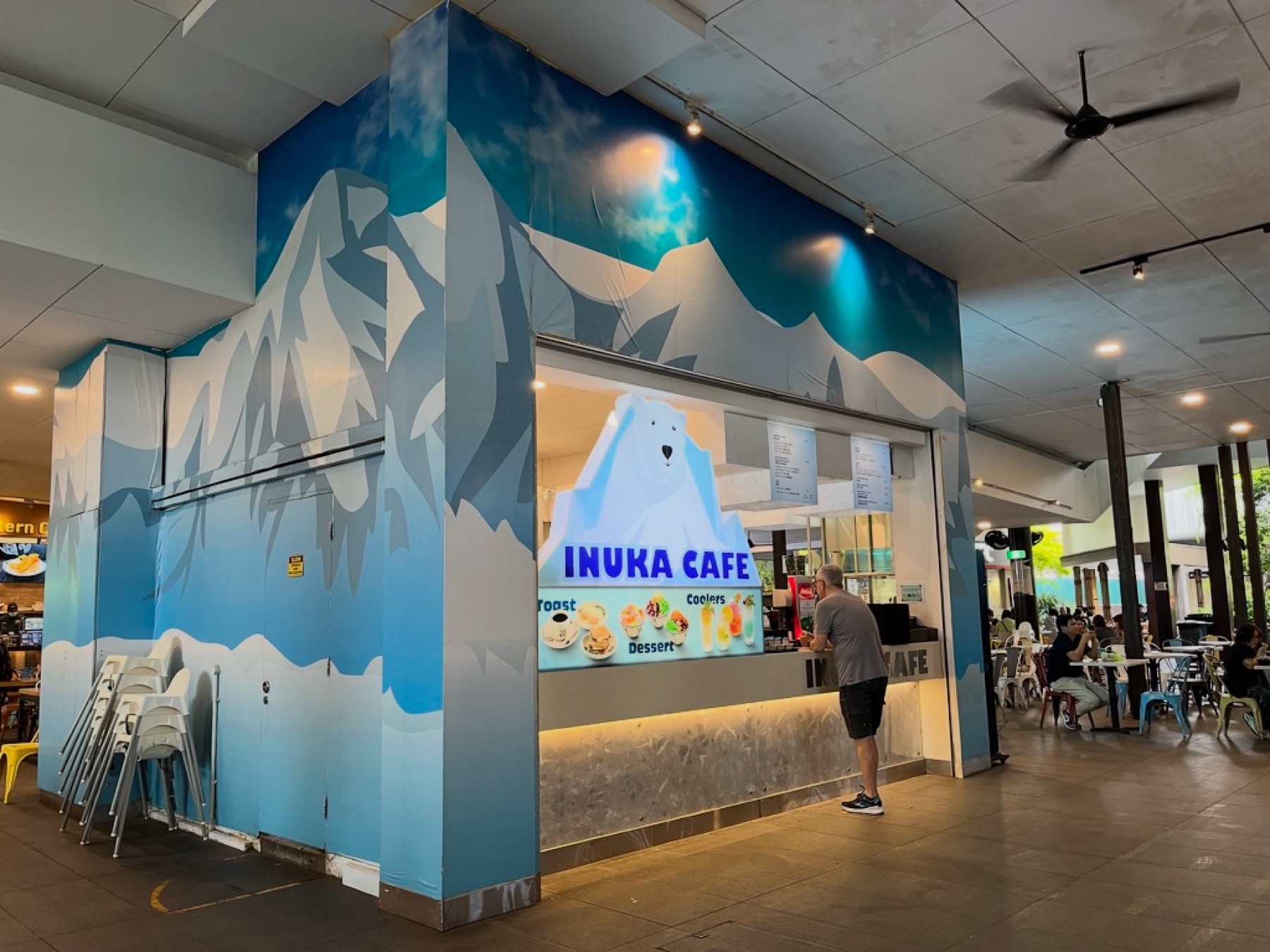 Inuka Cafe storefront painted with icy mountains